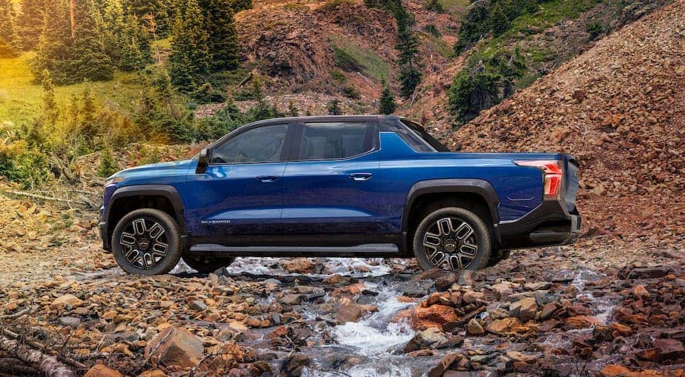 A blue 2025 Chevy Silverado EV RST is shown from the side.