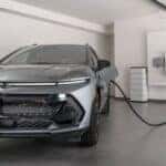 A gray 2025 Chevy Equinox EV for sale is shown charging.
