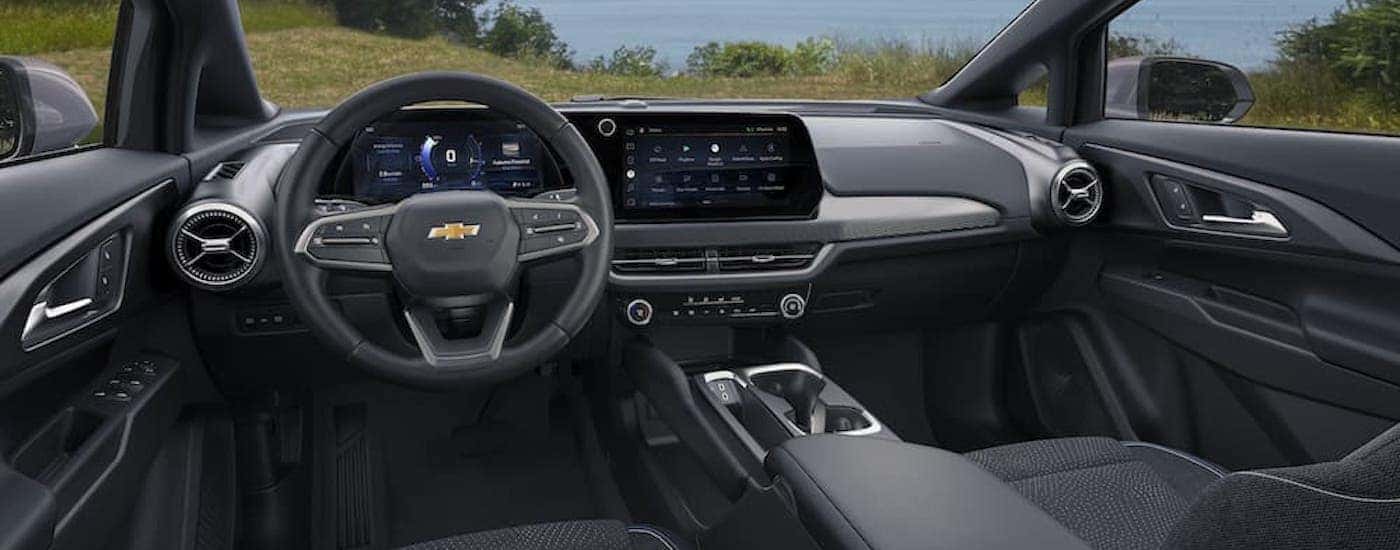 The black interior of a 2025 Chevy Equinox EV is shown from the drivers seat.