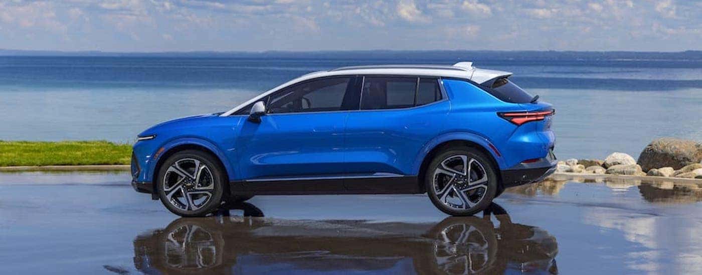A blue 2025 Chevy Equinox EV is shown from the side.