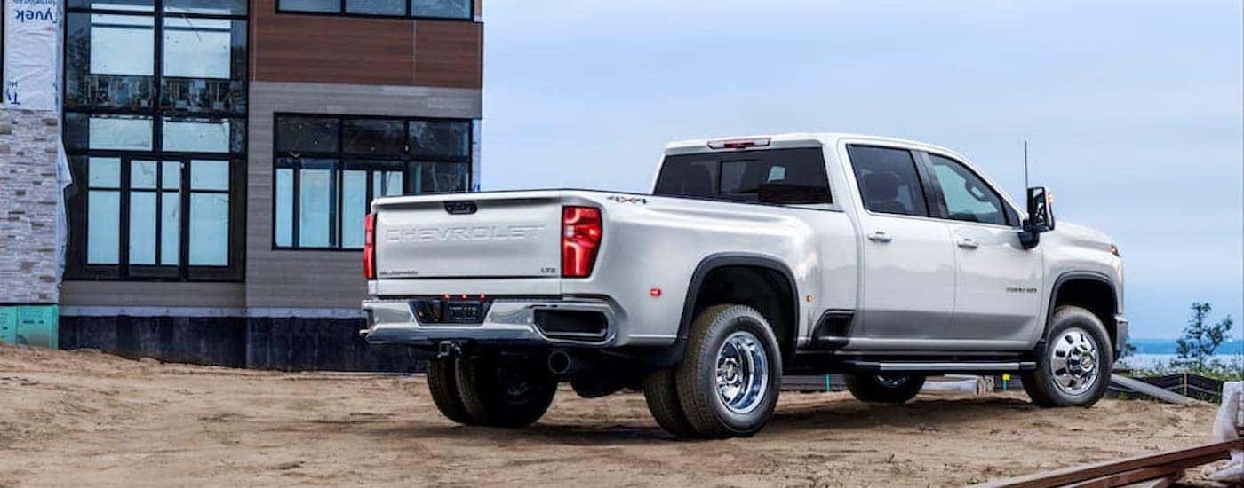 A white 2025 Chevy Silverado 3500 HD is shown from the rear at an angle.