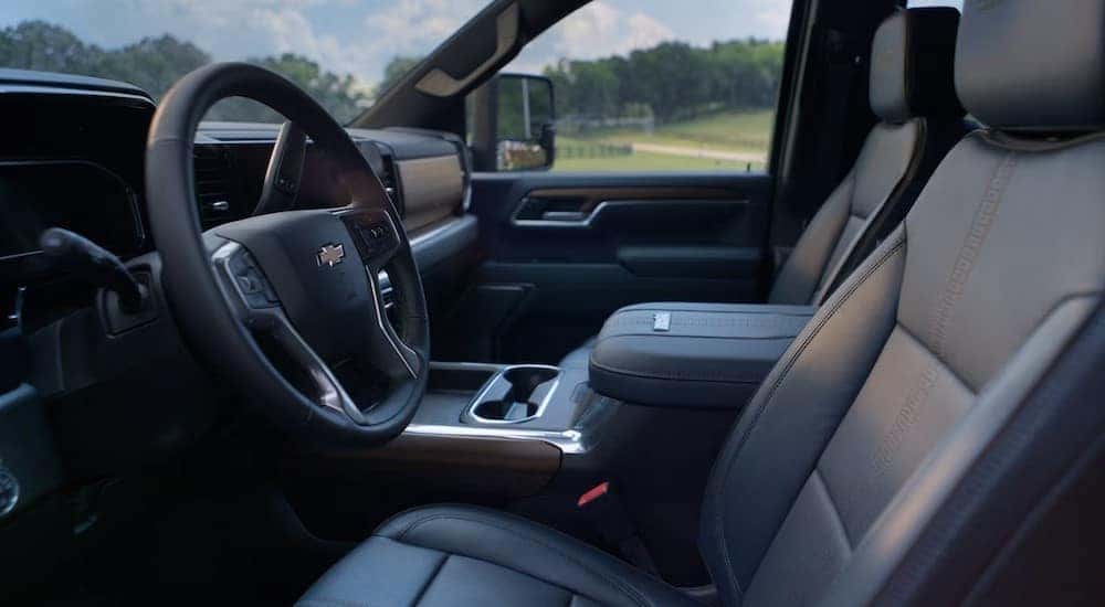 The black interior and dash are shown in a 2025 Chevy Silverado 3500HD.
