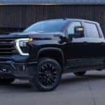 A black 2025 Chevy Silverado 3500HD High Country is shown parked on a driveway.