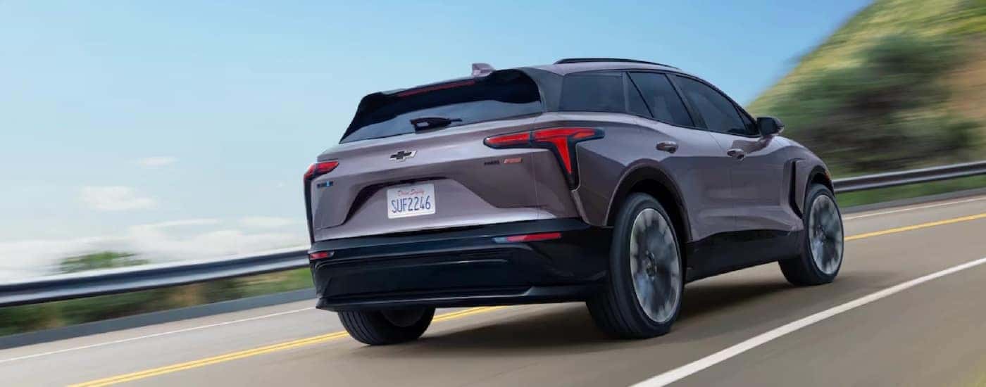A grey 2024 Chevy Blazer EV for sale near Mechanicsville is driving on a highway.