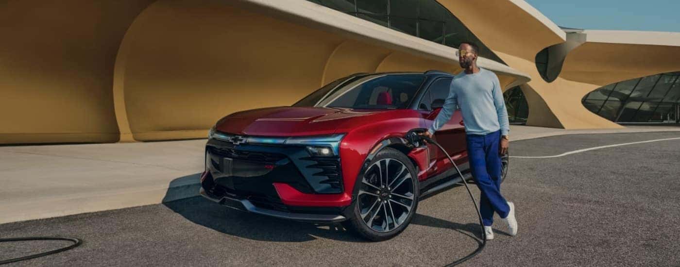 A red 2025 Chevy Blazer EV is charging.