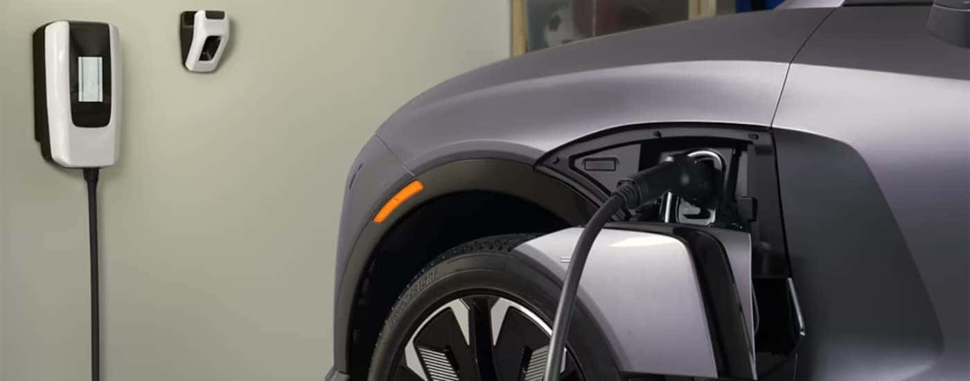 A 2024 Chevy Blazer EV for sale in Richmond is charging in a garage.