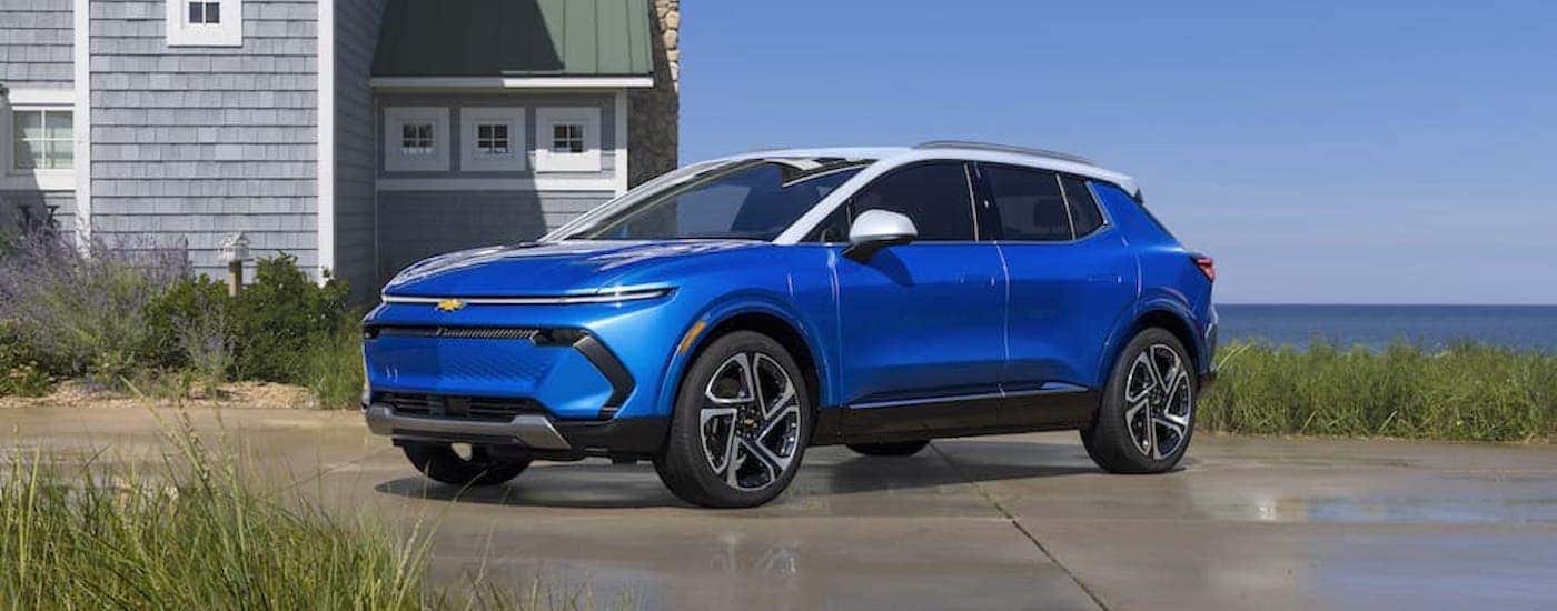 A blue 2025 Chevy Equinox EV is shown from the side.