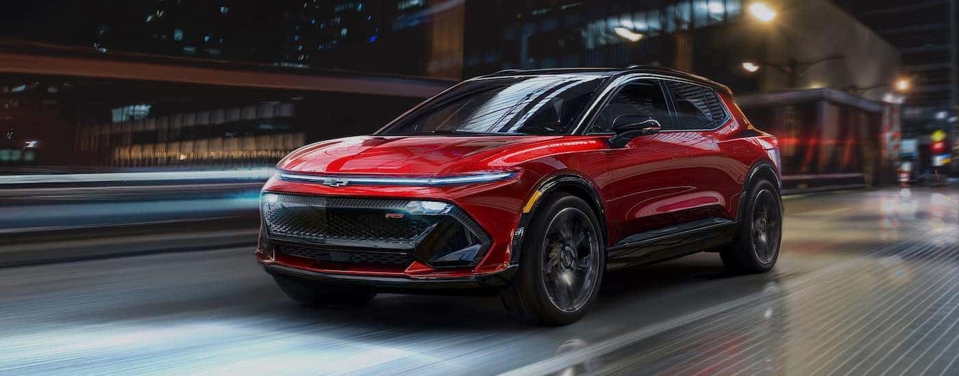 A red 2025 Chevy Equinox EV RS is shown from the front at an angle.