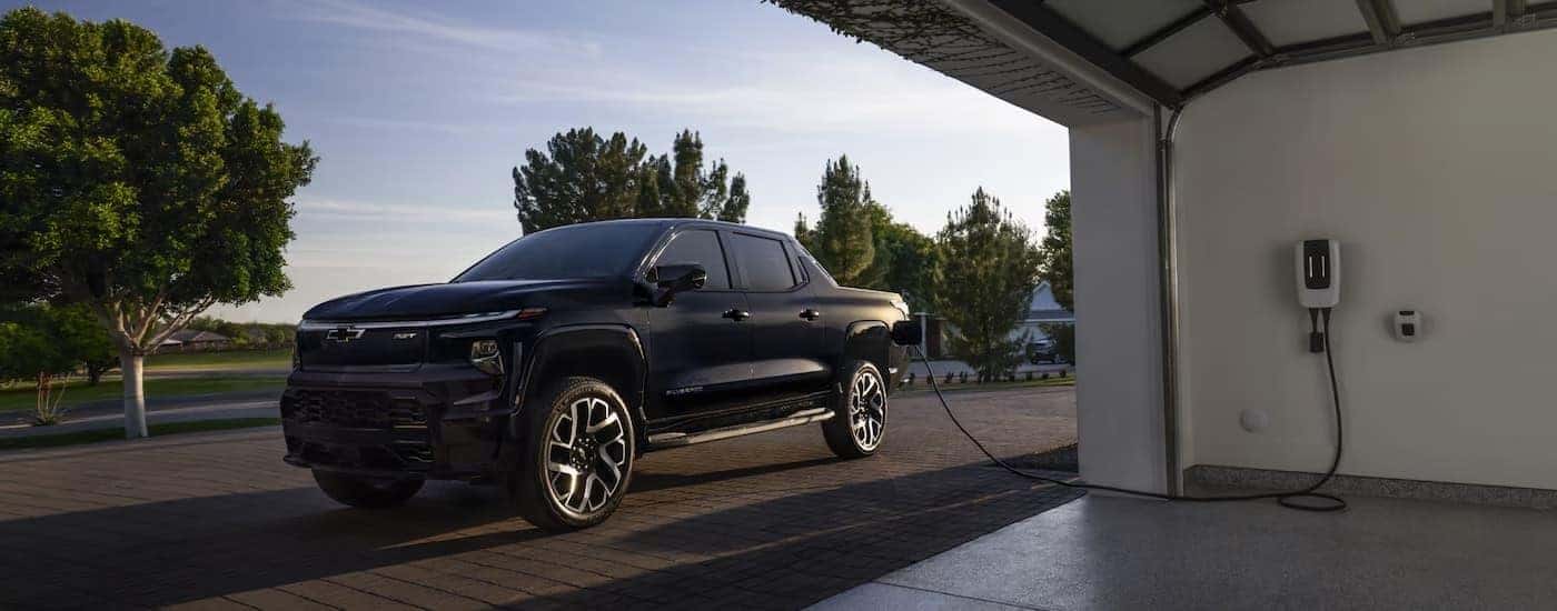 A black 2025 Chevy Silverado EV for sale near Fredericksburg while charging.