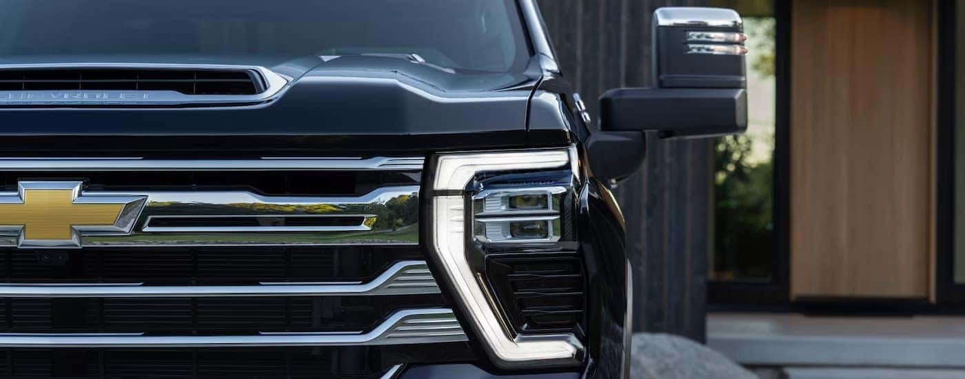Headlights and grille on a 2025 Chevy Silverado 2500 parked in a driveway