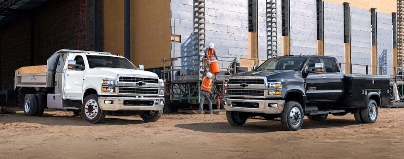A black 2021 Chevy Silverado 4500 parked near a white 2021 Chevy Silverado 5500.