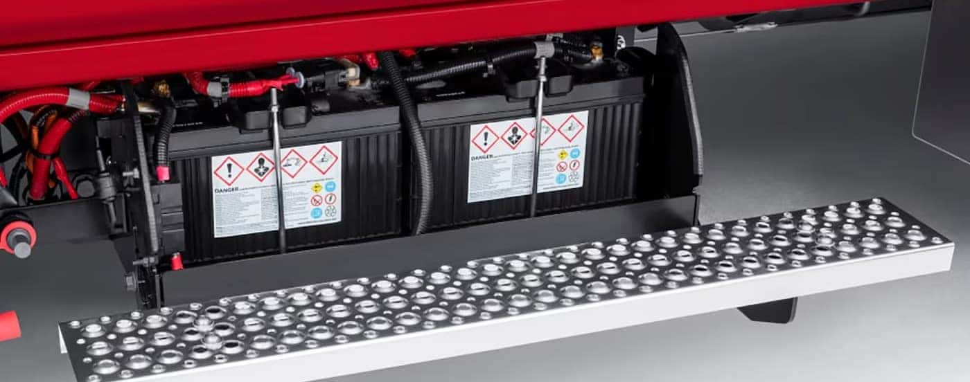 Accessible battery storage on a red 2025 Chevy Silverado 4500.
