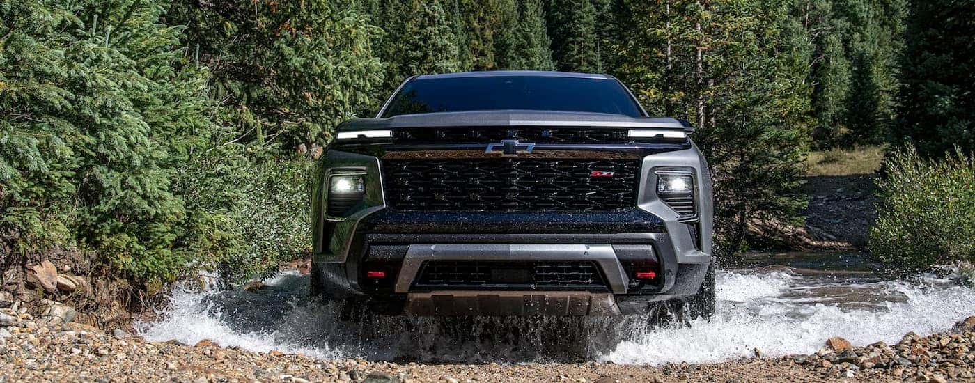 Grey 2024 Chevy Traverse Z71 driving through a river