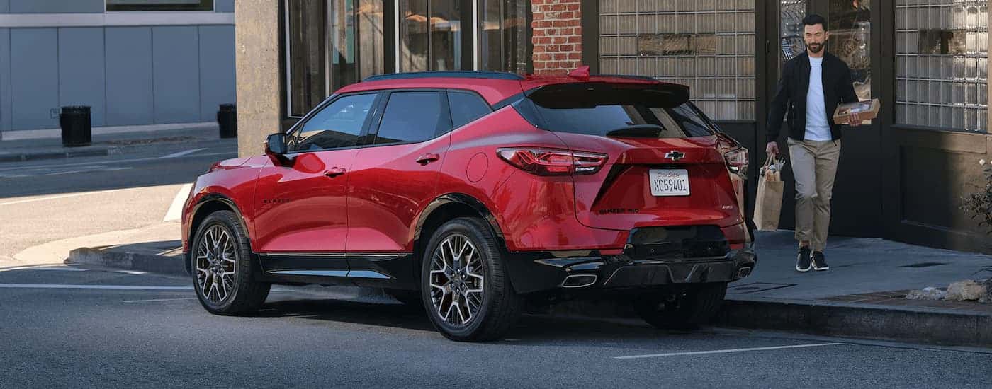 Red 2025 Chevy Blazer RS parked on the side of a city street