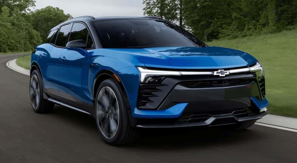Blue 2025 Chevy Blazer EV driving on a winding road