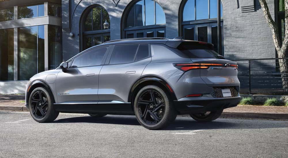 Silver 2025 Chevy Equinox EV RS parked on the side of a street