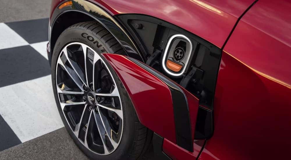 An open charging port on a red 2025 Chevy Blazer EV RS.
