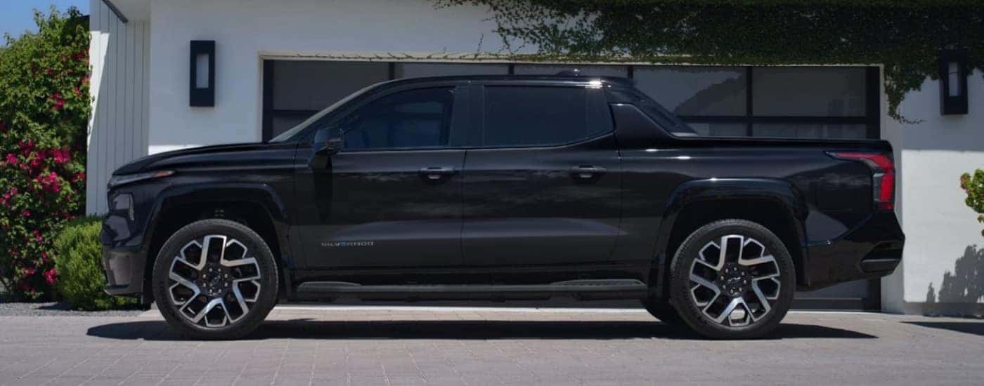 Black 2025 Chevy Silverado EV on a driveway after looking at EVs for sale near you