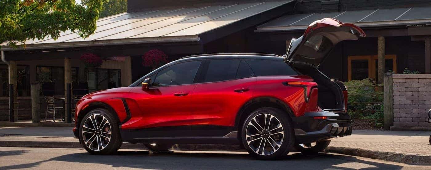 A red 2025 Chevy Blazer EV RS parked with its tailgate open.