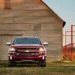 Red 2016 Chevy Silverado 1500 Z71 parked in front of a barn.