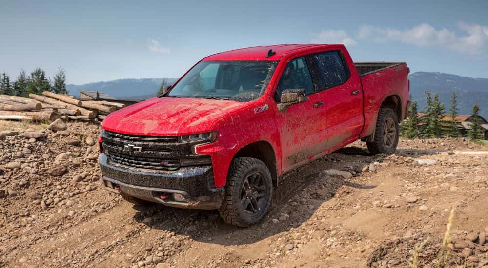 Red 2019 Chevy Silverado 1500 Trail Boss driving off-road.