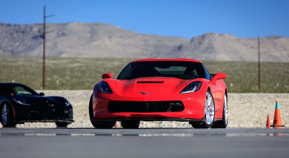 Used red 2015 Chevy Corvette C7 for sale parked head on.