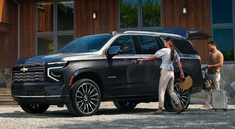 A black 2026 Chevy Tahoe parked on a driveway.