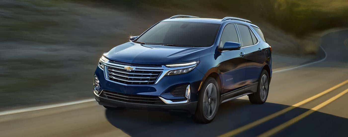 Blue 2022 Chevy Equinox driving down the road to look at used Chevys for sale near Mechanicsville