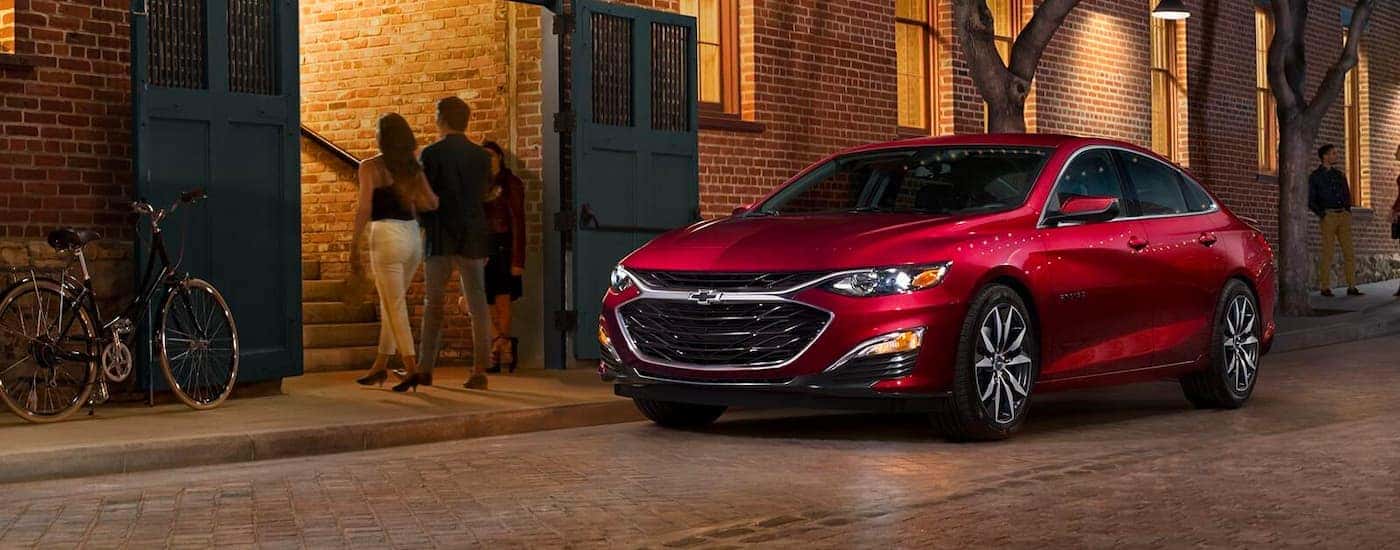 Red 2023 Chevy Malibu parked on a city street