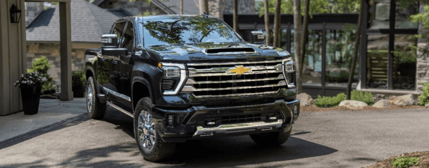 Black 2025 Chevy Silverado 2500 parked in front of a house