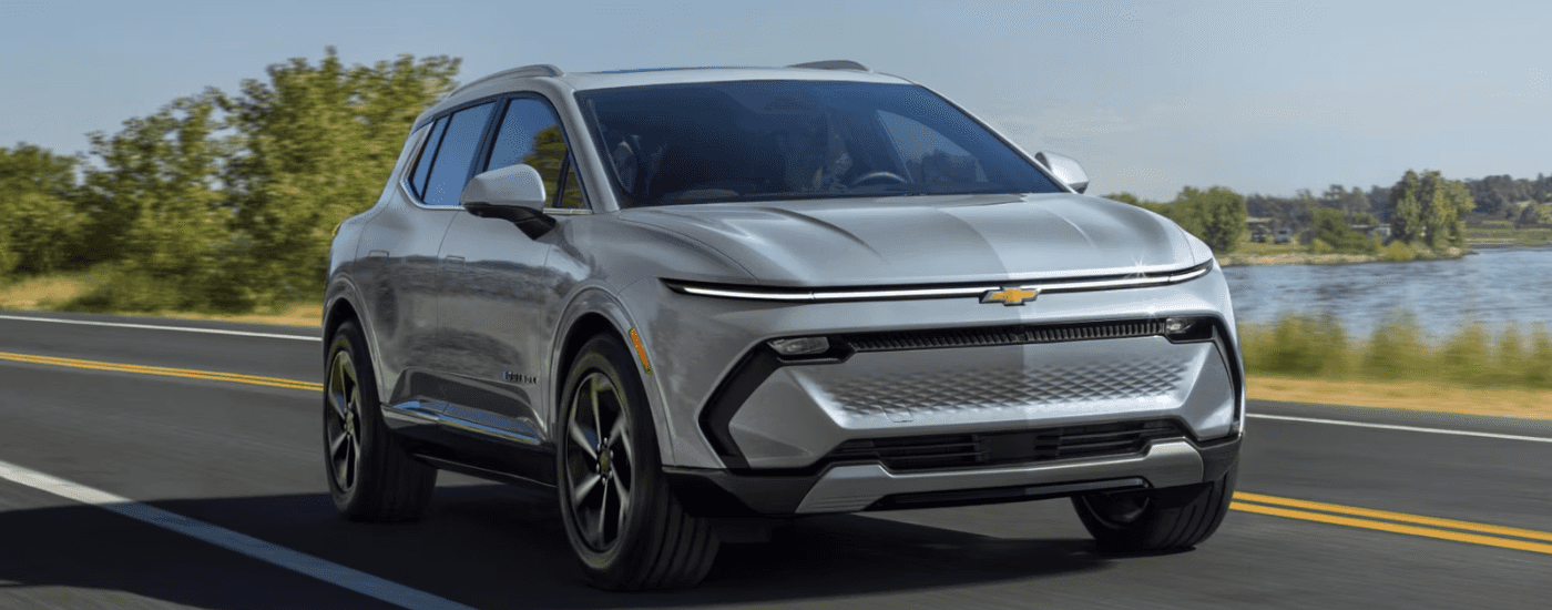 Silver 2026 Chevy Equinox EV driving to a car dealership in Richmond