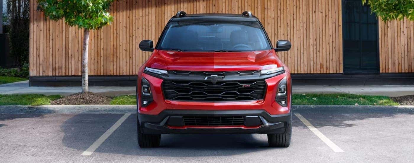 A red 2025 Chevy Equinox RS parked on a driving spot.