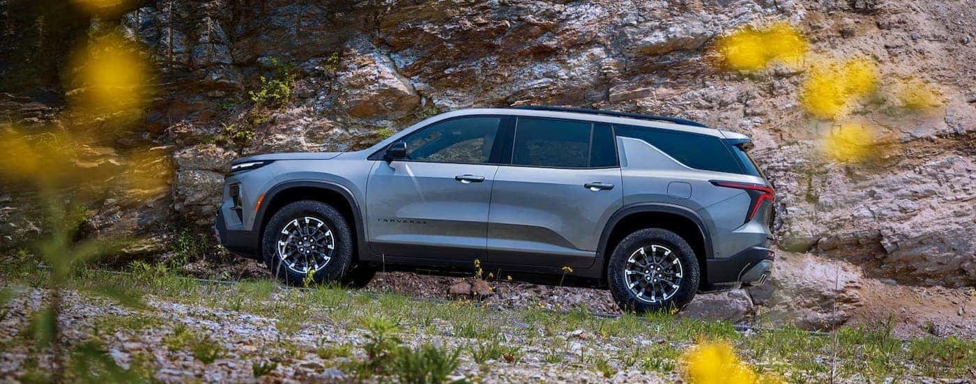 A silver 2026 Chevy Traverse off-roading.
