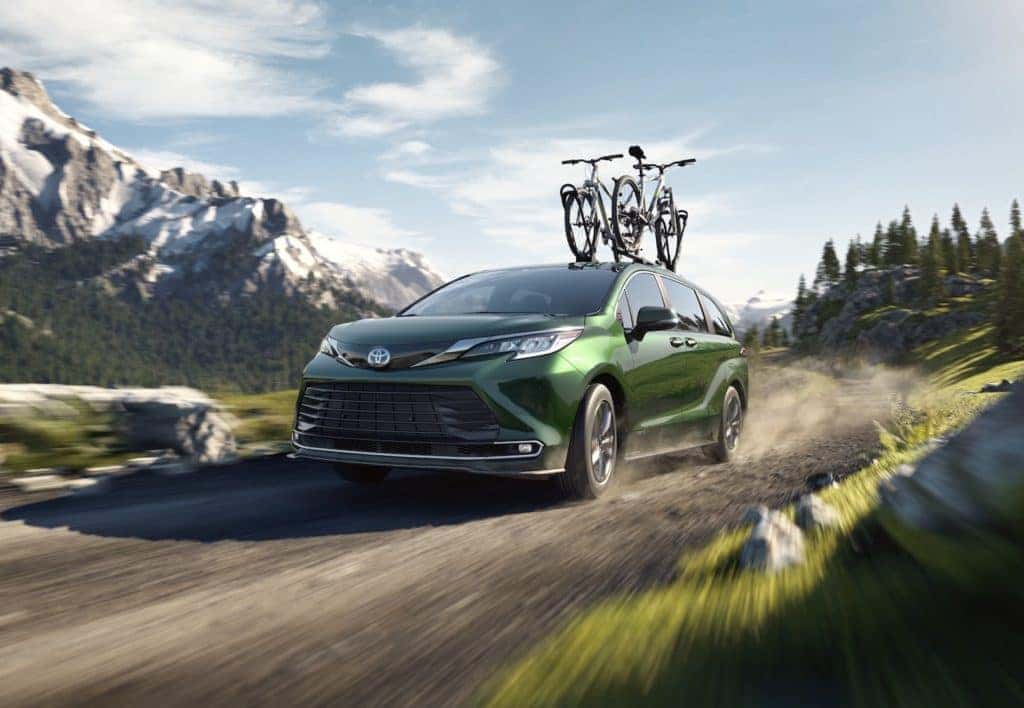 A Toyota Hybrid for Everyone at Penn Toyota | 2020 Toyota Sienna Hybrid driving on mountain trail with bike on roof