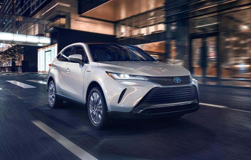 Toyota Hybrid for Everyone at Penn Toyota | White 2021 Toyota Venza Driving Through City at Night