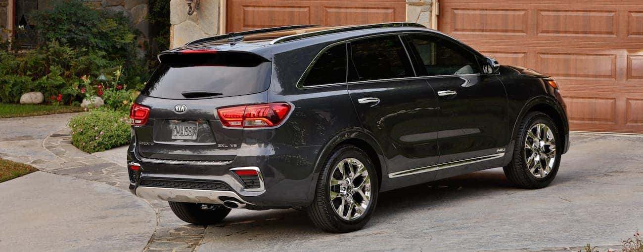 A dark gray 2019 Kia Sorento in a driveway in front of a garage