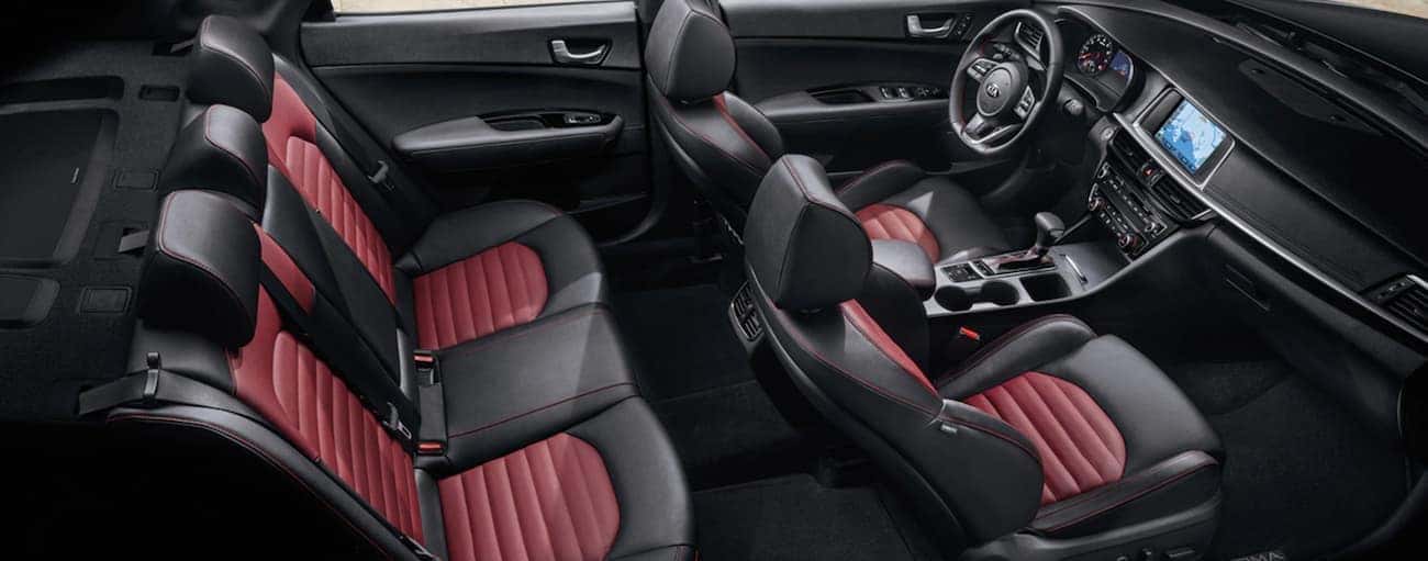 The black and red interior of a 2020 Kia Optima is shown.