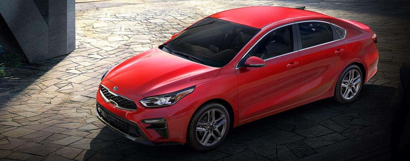 A red 2020 Kia Forte, winner of the 2020 Kia Forte vs 2020 Hyundai Elantra comparison, is shown from a high angle.