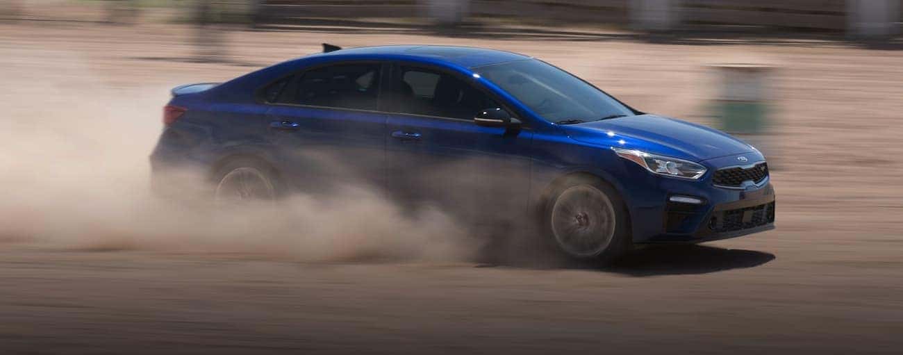 A blue 2020 Kia Forte is racing in the dirt near Freehold, NJ.