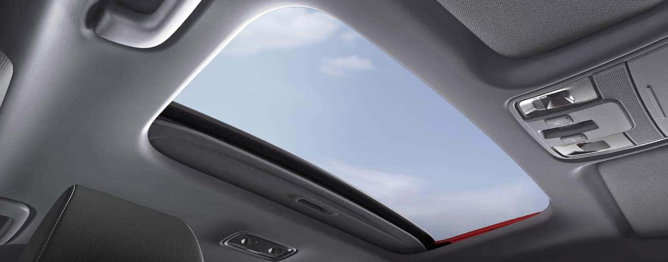 The sunroof is shown in the interior of a 2020 Kia Forte, which wins when comparing the 2020 Kia Forte vs 2020 Toyota Corolla.
