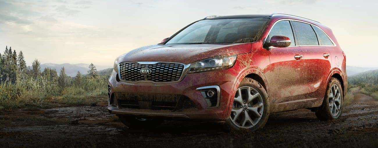 A red 2020 Kia Sorento is parked off-road in the mud after winning the 2020 Kia Sorento vs 2020 Mazda CX-9 comparison.