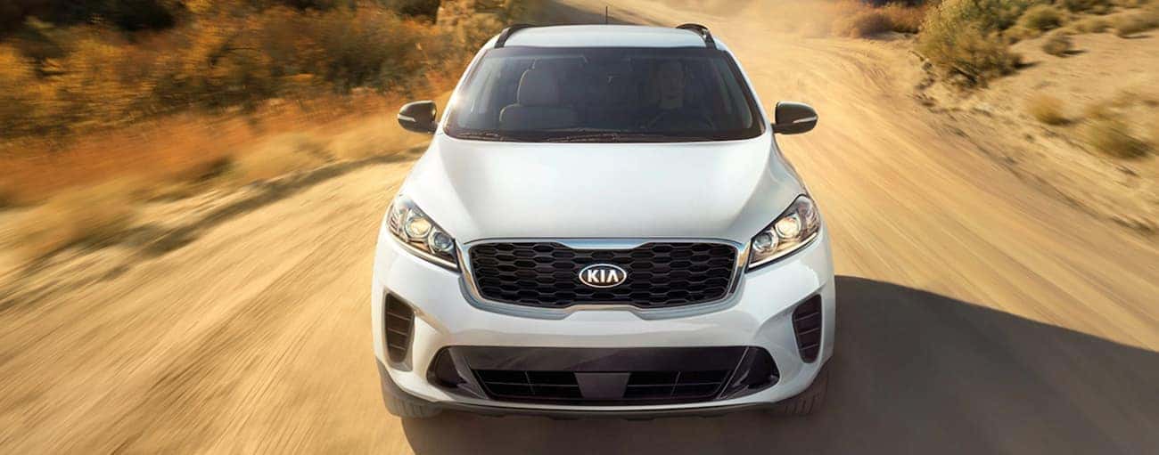 A white 2020 Kia Sorento is driving on a dirt road outside of Freehold, NJ.