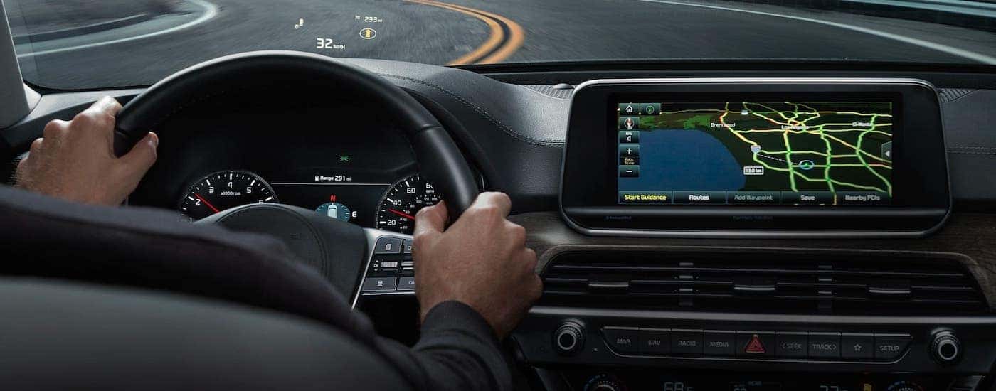 A driver is using the head up display on a 2021 Kia Telluride while driving around a track.