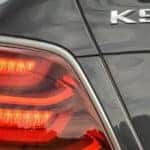 A close up is shown of the tail light and badging on a grey 2020 Kia K900.