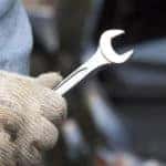 Man-with-glove-holding-a-wrench_15331853_xl-2015-11-e1545084029550 copy