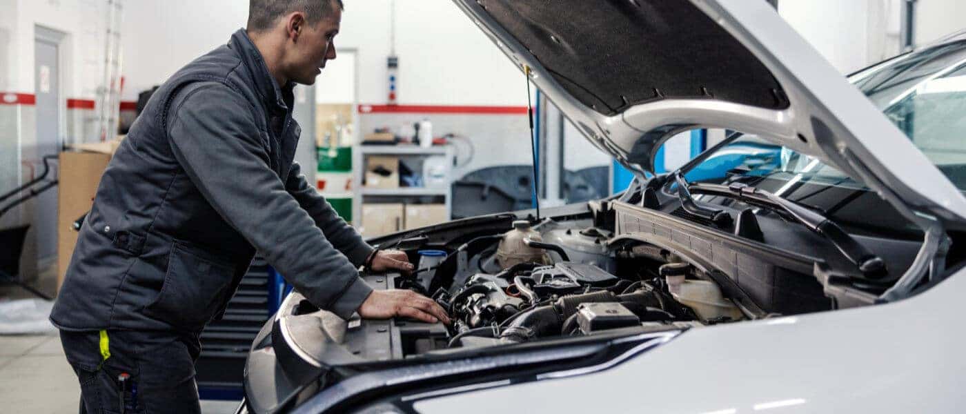 Service Inspection Technician Leaning Looking Under Hood
