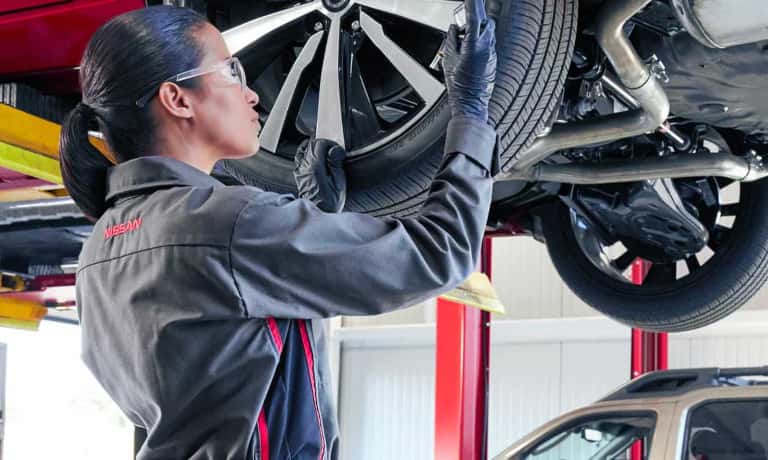 Nissan Service Technician Replacing Tire