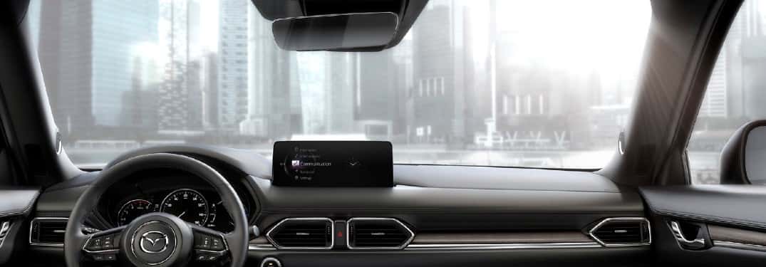 interior of a mazda car looking out windshield with mazda homelink garage door opener on rearview mirror
