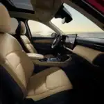 2026 Mazda CX-5 interior showing leather seats, touchscreen dashboard, and panoramic sunroof
