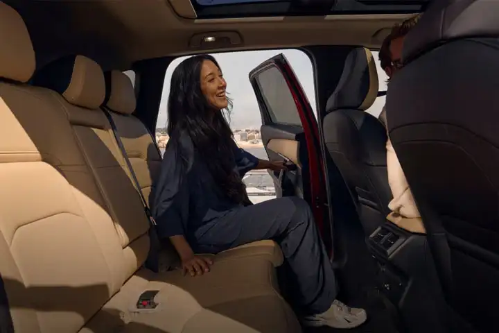 Rear seat of a 2026 Mazda CX-5 with the center armrest folded down, showing rear leg room at Sport Mazda South in Orlando, Florida